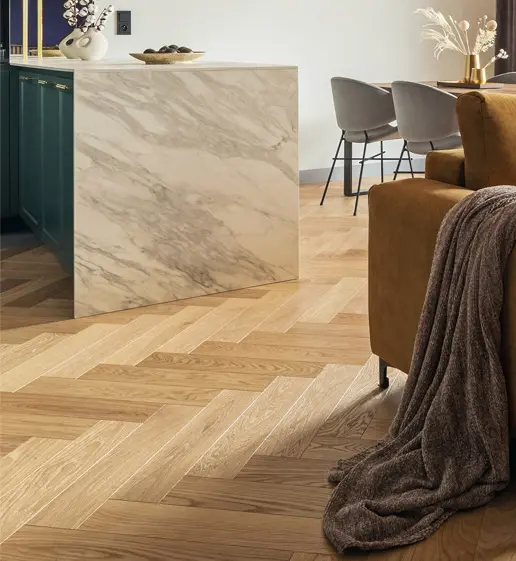 A living room with wooden floors and marble counter tops.